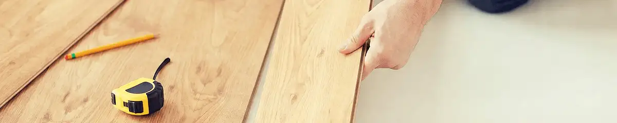 A professional installing wood flooring in Aurora, IL