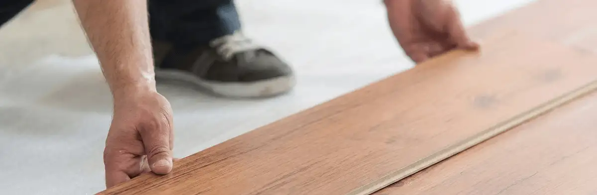 A professional installing laminate flooring in Aurora, IL